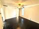 Bedroom showing a ceiling fan, dark hardwood floors, cream walls, and trim at 404 W Green St, Lebanon, IN 46052
