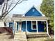 Charming blue home featuring a covered front porch, white trim, and landscaped surroundings at 404 W Green St, Lebanon, IN 46052