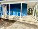 Inviting covered porch, with white pillars, a mailbox, and ample space to relax at 404 W Green St, Lebanon, IN 46052