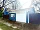 Detached one car garage with white door and blue siding and a privacy fence at 404 W Green St, Lebanon, IN 46052