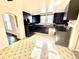 Kitchen featuring black appliances, cabinets, and light patterned flooring at 404 W Green St, Lebanon, IN 46052