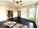 Spacious living room featuring dark hardwood floors, ceiling fan, and beautiful french doors at 404 W Green St, Lebanon, IN 46052