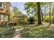 Backyard featuring a charming pergola and views of mature trees and landscaping at 4151 N Pennsylvania St, Indianapolis, IN 46205