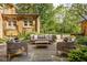 Secluded backyard featuring patio with outdoor seating surrounded by mature trees and gardens at 4151 N Pennsylvania St, Indianapolis, IN 46205