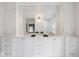 Bright bathroom with double vanity, quartz countertop, and decorative wall sconces at 4151 N Pennsylvania St, Indianapolis, IN 46205