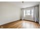 Empty bedroom with hardwood floors and sheer curtains for natural light at 4151 N Pennsylvania St, Indianapolis, IN 46205