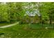 Charming brick home with lush green lawn and mature trees offers a serene and private setting at 4151 N Pennsylvania St, Indianapolis, IN 46205