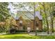 Charming two-story brick home featuring a slate roof and lush landscaping at 4151 N Pennsylvania St, Indianapolis, IN 46205