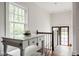 Bright hallway featuring a marble-top island and stairs leading to a doorway at 4151 N Pennsylvania St, Indianapolis, IN 46205