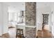 Open concept kitchen with brick column, white cabinetry, and stainless steel appliances at 4151 N Pennsylvania St, Indianapolis, IN 46205