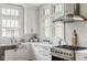 Bright, white kitchen featuring stainless steel appliances and natural light at 4151 N Pennsylvania St, Indianapolis, IN 46205