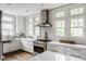Modern kitchen with white cabinets, stainless steel appliances, and ample natural light at 4151 N Pennsylvania St, Indianapolis, IN 46205