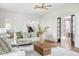Open-concept living room with hardwood floors and view of staircase at 4151 N Pennsylvania St, Indianapolis, IN 46205
