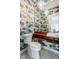 Unique powder room showcases patterned wallpaper and modern fixtures with a wood shelf at 4151 N Pennsylvania St, Indianapolis, IN 46205