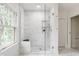 Modern marble shower with glass door, built-in niche, and elegant fixtures at 4151 N Pennsylvania St, Indianapolis, IN 46205