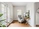 A peaceful sitting area features a comfortable chair and wooden desk near the entryway at 4151 N Pennsylvania St, Indianapolis, IN 46205