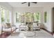 Inviting sunroom filled with natural light, showcasing a cozy seating area and views of the outdoors at 4151 N Pennsylvania St, Indianapolis, IN 46205