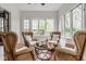 Cozy sunroom featuring wicker chairs, offering a relaxing space with natural light at 4151 N Pennsylvania St, Indianapolis, IN 46205