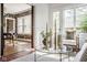 Sunny sunroom featuring decor, large windows, and a view into an adjacent dining area at 4151 N Pennsylvania St, Indianapolis, IN 46205
