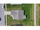 An aerial shot reveals a home with a manicured lawn, fenced backyard, and a tidy roof at 4323 Stubbington Ln, Indianapolis, IN 46239