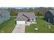 Well-kept home in a suburban neighborhood showcases a spacious yard, inviting curb appeal, and a driveway at 4323 Stubbington Ln, Indianapolis, IN 46239