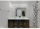 Bathroom with a double vanity sink, black and gold fixtures, and a shower-tub combination at 4323 Stubbington Ln, Indianapolis, IN 46239