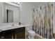 Bright bathroom with a dark wood vanity, double sinks, and a shower-tub combination at 4323 Stubbington Ln, Indianapolis, IN 46239