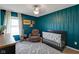 Beautiful bedroom with a crib, ceiling fan, accent wall, geometric rug and a recliner at 4323 Stubbington Ln, Indianapolis, IN 46239