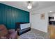 Bright bedroom features board and batten accent wall, crib, geometric rug and doorway to the kitchen at 4323 Stubbington Ln, Indianapolis, IN 46239