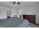 A well-lit bedroom with tray ceilings, hardwood floors, and ample storage space at 4323 Stubbington Ln, Indianapolis, IN 46239