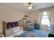 Bedroom with gold crib, accent chair, and a colorful area rug at 4323 Stubbington Ln, Indianapolis, IN 46239