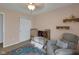Charming bedroom with a golden crib, recliner, ornate shelves, and colorful rug at 4323 Stubbington Ln, Indianapolis, IN 46239