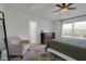 A spacious bedroom with tray ceilings, a large window, and a comfortable seating area at 4323 Stubbington Ln, Indianapolis, IN 46239