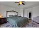 Bright bedroom featuring tray ceilings, an upholstered headboard, and neutral decor at 4323 Stubbington Ln, Indianapolis, IN 46239