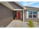 Inviting entryway featuring a bright red door and stylish landscaping at 4323 Stubbington Ln, Indianapolis, IN 46239