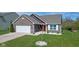 Attractive home with brick accents, manicured landscaping, and a welcoming red front door at 4323 Stubbington Ln, Indianapolis, IN 46239