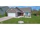 Well-maintained front yard and brick home, featuring a red front door and attached two-car garage at 4323 Stubbington Ln, Indianapolis, IN 46239