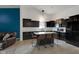 Modern kitchen with black cabinets, white countertops, a kitchen island, and pendant lighting at 4323 Stubbington Ln, Indianapolis, IN 46239