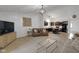 Inviting living room with an open floorplan leading to a modern kitchen with a bar at 4323 Stubbington Ln, Indianapolis, IN 46239
