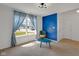 Comfortable living room with large windows, a bright accent wall, and stylish decor at 4323 Stubbington Ln, Indianapolis, IN 46239