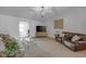 Spacious living room featuring neutral carpeting, modern lighting, and comfortable seating at 4323 Stubbington Ln, Indianapolis, IN 46239