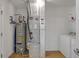 Utility area showcasing water heater, furnace, and white washer and dryer at 4323 Stubbington Ln, Indianapolis, IN 46239