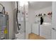 Functional utility room with washer, dryer, furnace, water heater, and storage shelving at 4323 Stubbington Ln, Indianapolis, IN 46239