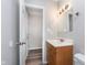 Bathroom featuring a vanity with oak cabinets and a view into a hallway at 4326 Burrwood Dr, Indianapolis, IN 46235