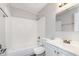 Bright bathroom featuring a white subway tile shower-tub combination and white single sink vanity at 4326 Burrwood Dr, Indianapolis, IN 46235