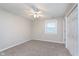 Cozy bedroom with a ceiling fan, closet, and a window for natural light at 4326 Burrwood Dr, Indianapolis, IN 46235