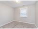 Bright bedroom with a window, plush carpet, and fresh paint at 4326 Burrwood Dr, Indianapolis, IN 46235