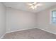 Neutral bedroom with a ceiling fan and a window providing natural light at 4326 Burrwood Dr, Indianapolis, IN 46235