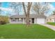 Charming single-story home with well-manicured lawn and inviting facade at 4326 Burrwood Dr, Indianapolis, IN 46235