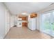 Bright kitchen featuring wood cabinets, white appliances, and sliding glass doors at 4326 Burrwood Dr, Indianapolis, IN 46235